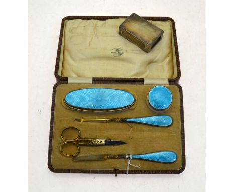 A silver, gilt and blue basse-taille enamel manicure set in fitted Mappin & Webb case, maker AC, Birmingham 1927, to/w a matc