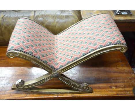 A gilt framed slipper form overstuffed gout stool