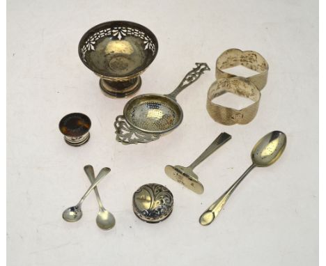 Various oddments of silver, including a pair of engine-turned oval napkin rings, tea strainer, various spoons, two bottle-top