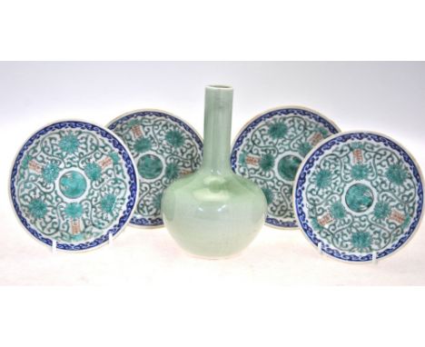 A green monochrome bottle vase; together with four Chinese blue and green enamel saucer dishes; each dish, 13 cm diameter, an