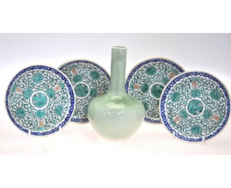 A green monochrome bottle vase; together with four Chinese blue and green enamel saucer dishes; each dish, 13 cm diameter, an