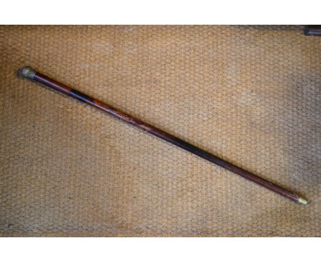 An antique malacca swordstick with electroplated pommel, the etched Toledo blade with folding cross-piece