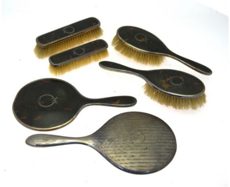 Two pairs of silver tortoiseshell and pique-work hairbrushes with hand-mirror, Birmingham 1926/27, to/w an engine-turned silv