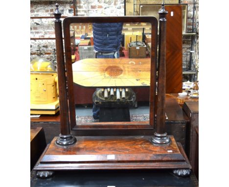 A large Regency figured mahogany platform mirror, the rectangular plate finial tripod on turned pillars to a moulded edge bas