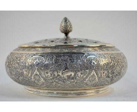 A Persian white metal pot pourri bowl with pierced domed cover and knop finial, finely chased and engraved with floral and fo