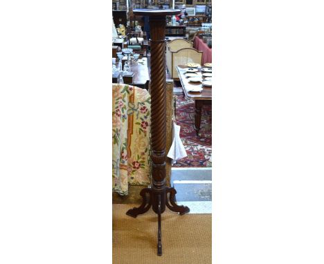 A mahogany foliate-carved and spiral reeded  torchère, on later tripod base.  143cm high