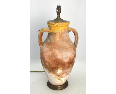 A classical terracotta amphora with incised wheel decoration, two strap handles converted to a lamp, approx 42 cm high exclud