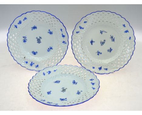 Three Meissen plates with reticulated borders painted with blue floral sprigs, underglaze blue crossed swords,  23.4 cm diam.