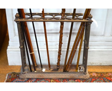 A Victorian style cast iron six circular division stick stand with removable drop tray in the Coalbrookdale manner, 61 cm hig