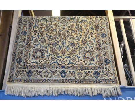 A Persian Nian rug, the cream ground with centre medallion and trailing vine design in blue grey, 2.20 x 1.20 m