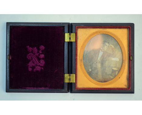 A mid 19th century Dagguerotype, portrait of an elegant gentleman in evening dress, in gilt mount and composite pocket case