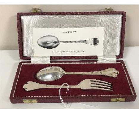 A cased pair of silver spoons and matching silver fork, in the James II style