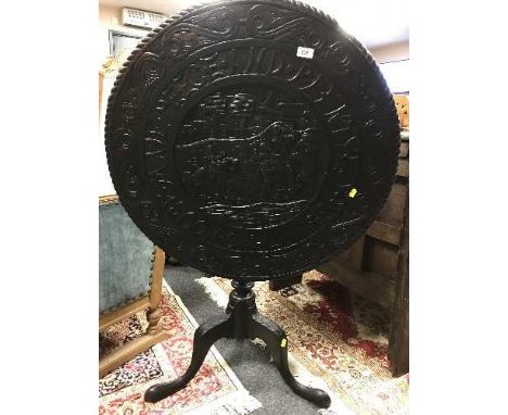 A Georgian carved oak circular tilt-topped table, on a tripod base, width 80 cm. 