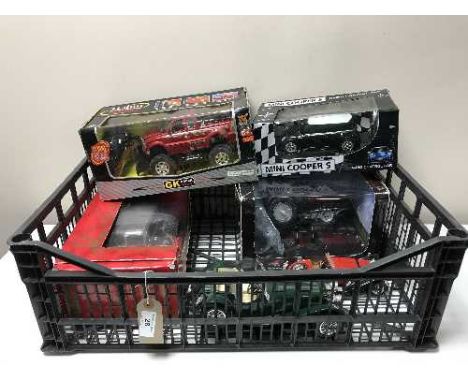 A crate of two boxed large scale die cast vehicles, two others and two RC cars  