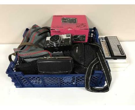 A basket of cameras, digital camera and a Stylophone 