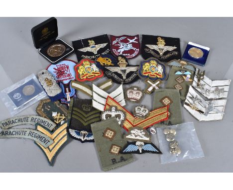 An attributed collection of Paratrooper and SAS badges, worn by Charles Thomas William, comprising cap badges, pin badges, a 