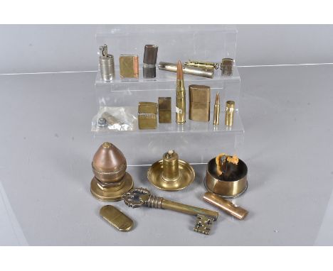 A collection of Trench Art and brass lighters, including book lighters, shell casing lighters, a Naval Fuse lighter and more,