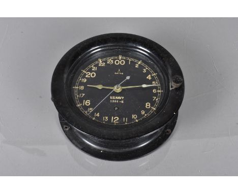 A US Navy Clock by Seth Thomas, serial 1366-E, in black Bakelite-style casing, complete with key
