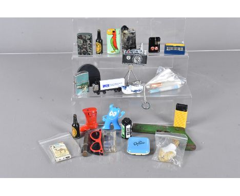 A collection of Novelty lighters, to include KKW lighter in the form of a camera on tripod, plastic pelican, a light bulb, Ma