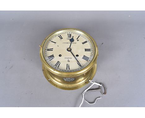 A Fattorini &amp; Son Ltd brass ship's clock, with strike movement, with black Roman numerals on cream dial, dial 19cm diamet