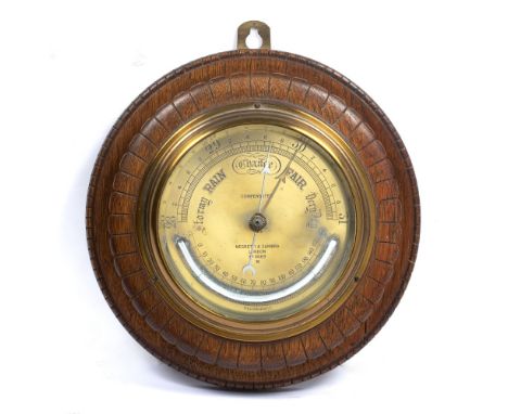 19th Century oak framed barometer with brass face and temperature gauge, by Negretti and Zambra of London Number 4669