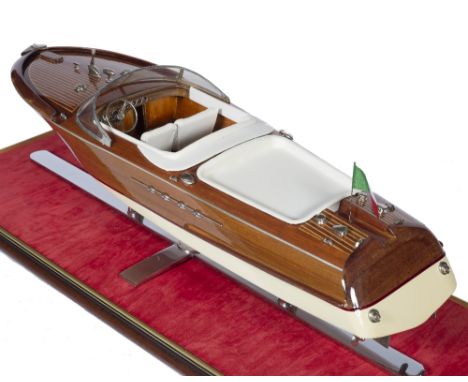 Cased Riva model speedboat with an Italian flag at the back with cream leather upholstery and a chrome or metal stand, 65cm a
