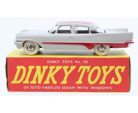 Dinky: A boxed, Dinky Toys, 192, De Soto Fireflite Sedan with Windows, two-tone grey and red body, in yellow and red unillust