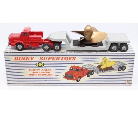 Dinky: A boxed Dinky Supertoys, Mighty Antar Low Loader with Propeller, 986, red cab, grey trailer with propeller load, paint