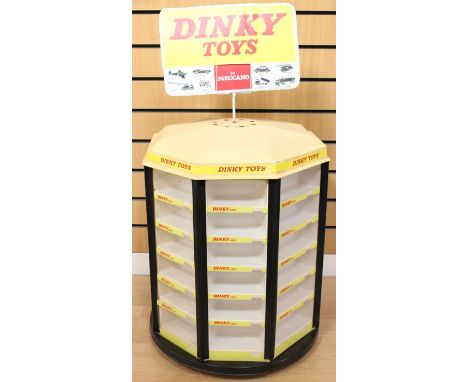 Dinky: A Dinky Toys by Meccano, shop display stand, comprising 48 compartments, upon rotating stand, with replacement cardboa