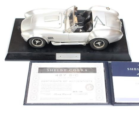 Franklin Mint: A Shelby Cobra 1:12 scale, fine Pewter model, No. 909/1000. R/h exhaust loose, complete with certificate.