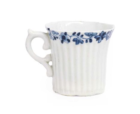 A Worcester Porcelain Coffee Can, circa 1754, lobed and with moulded vertical reeding, having scroll formed handle and painte