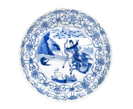A Chinese Porcelain Dish, Kangxi,  with moulded rim, painted in underglaze blue with a hunting scene depicting archers on hor
