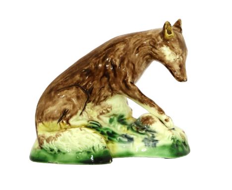 A Ralph Wood Creamware Model of a Fox, circa 1780, sitting on a mound with forepaw on a bird, picked out in typical glazes 12