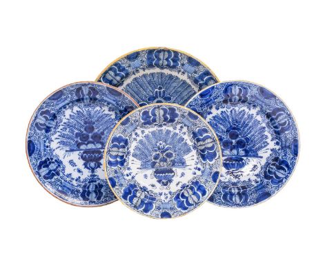 Four Dutch Delft Dishes, circa 1750, painted in blue with the "Peacock" pattern under coloured rims, largest with BP, makers 