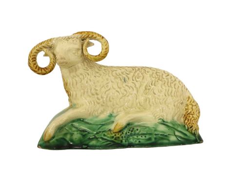 A Ralph Wood-Type Creamware Figure of a Ram, circa 1770, naturalistically modelled recumbent, with ochre markings on a green 