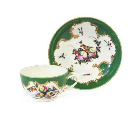A Worcester Porcelain Teacup and Saucer, circa 1770, painted with "Spotted Fruit" and with insects and flower sprigs on an ap