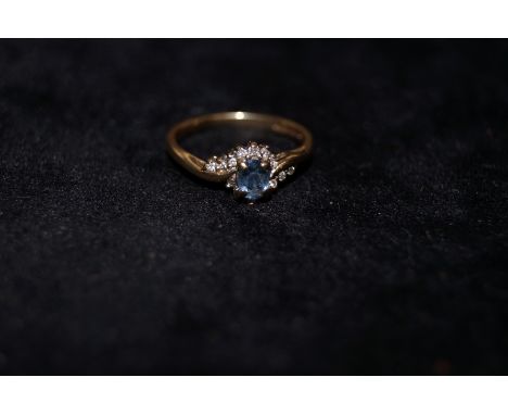 9 ct gold ring with chip diamonds and central blue stone possibly topaz Size-K