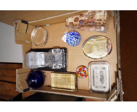 A collection of paperweights to include a frosted glass model of a car 