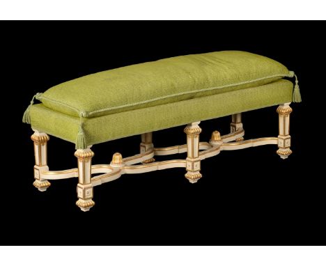 A 20th century white painted and parcel gilt bench stool in early 19th century style, 134cm wide 