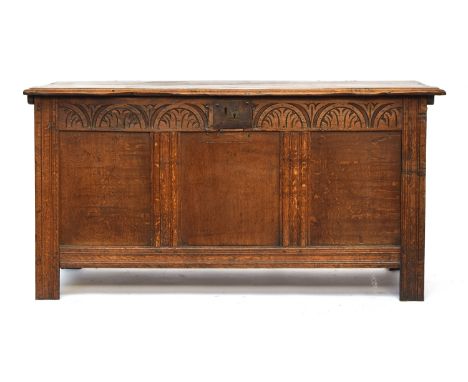 An early 18th century oak three panel coffer, demilune carved frieze, with panelled sides, 128cm wide, 57cm deep, 66cm high 