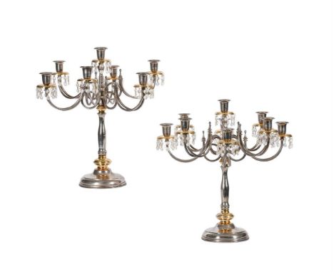 A pair of 20th century chrome and gilt metal seven light candelabra, the drip-pans with facetted glass drops, 51cm high 