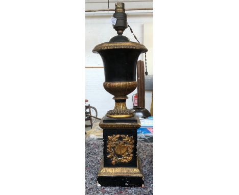 An ebonised and parcel gilt table lamp in the form of an urn, on a square plinth base, 46cmH overall 