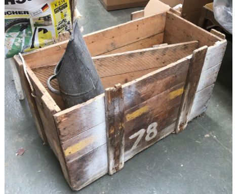 A vintage packing crate with a coal scuttle 