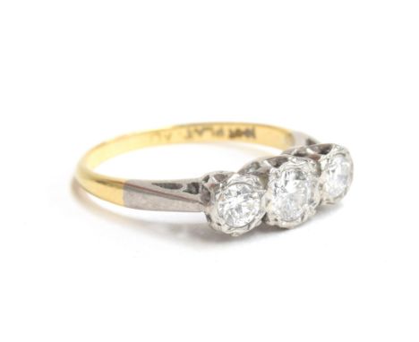 An early 20th century 18ct gold and platinum diamond trilogy ring, total diamond weight approx. 0.5ct, size K 1/2, 2.2g 