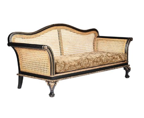 An ebonised, parcel gilt and caned sofa, 20th century, 225cm wide 