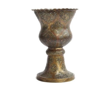 A possibly early gilded brass mamluk lamp, pierced detail, the quatrefoil panels containing script and floral motifs, 21.5cm 