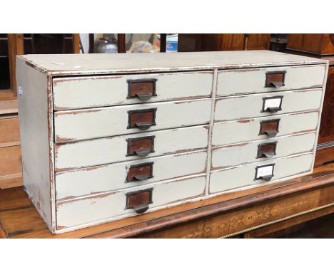 A vintage white painted filing cabinet of ten drawers, 77x25x33cmH 