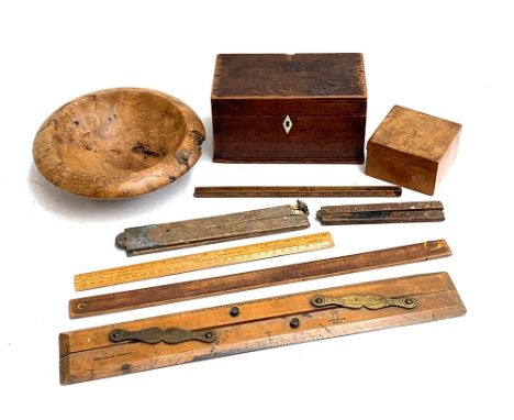 A turned burr wood fruit bowl, 23cmD; a treen box, 10cmW; small mahogany tea caddy, 20.5cmW; and various rulers 