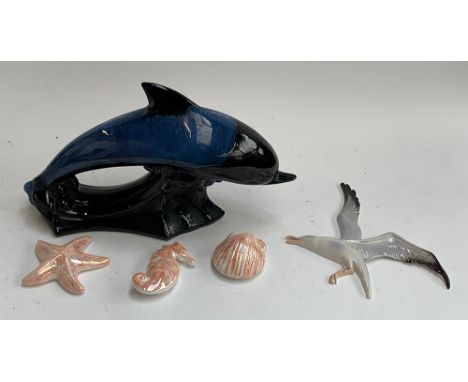 A large blue glaze Poole pottery style leaping dolphin, 42cmL; together with a Branksome pottery seagull wall plaque, ceramic