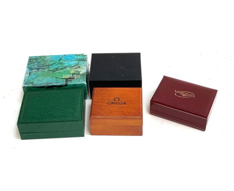 Three empty watch boxes: Rolex, Omega and Longines 